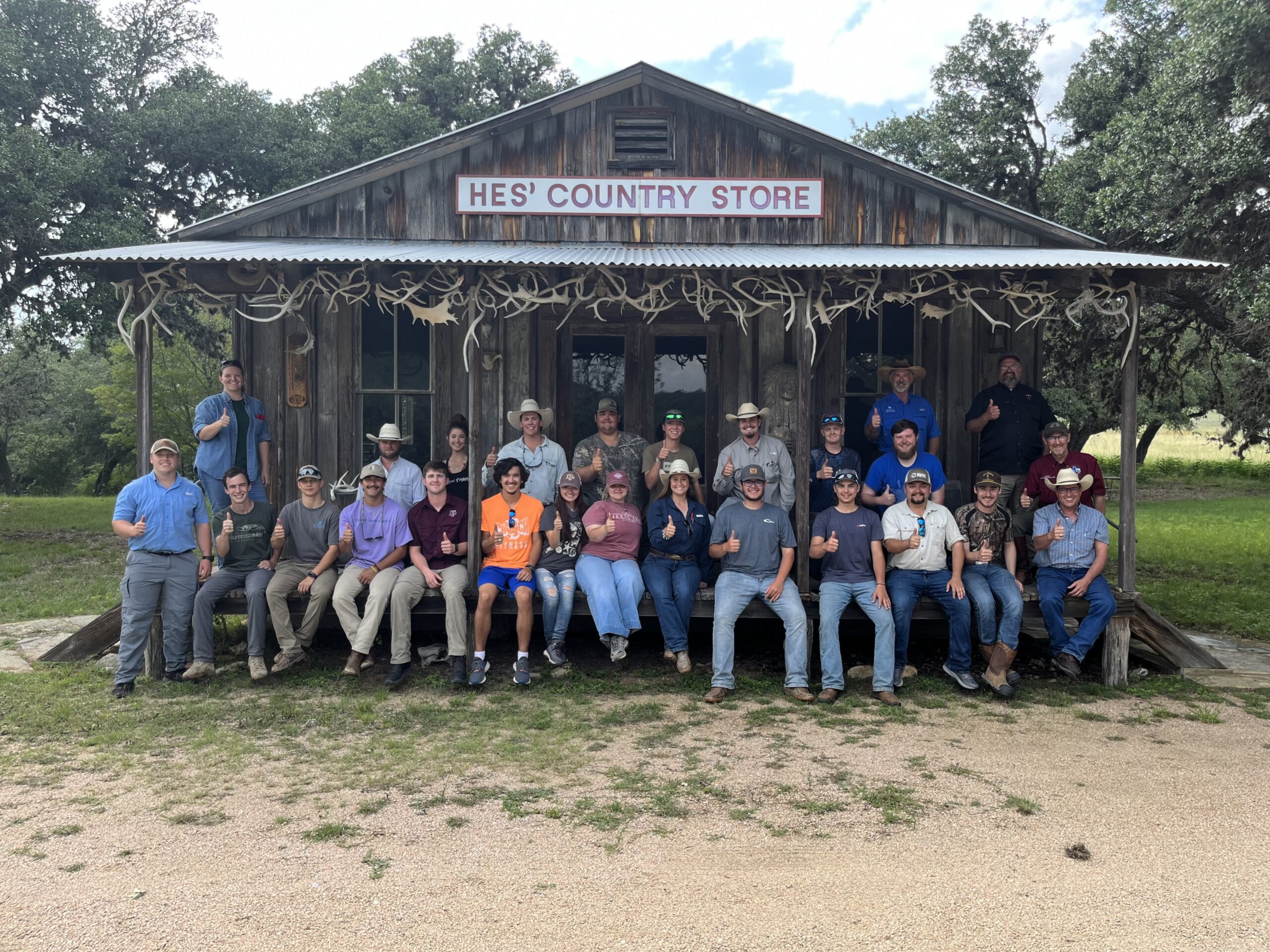 Students pose on the porch of an old country store.
